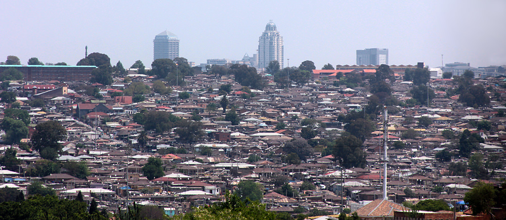 A view of the sprawling Alexandra Township with the Sandton skyline looming behind.