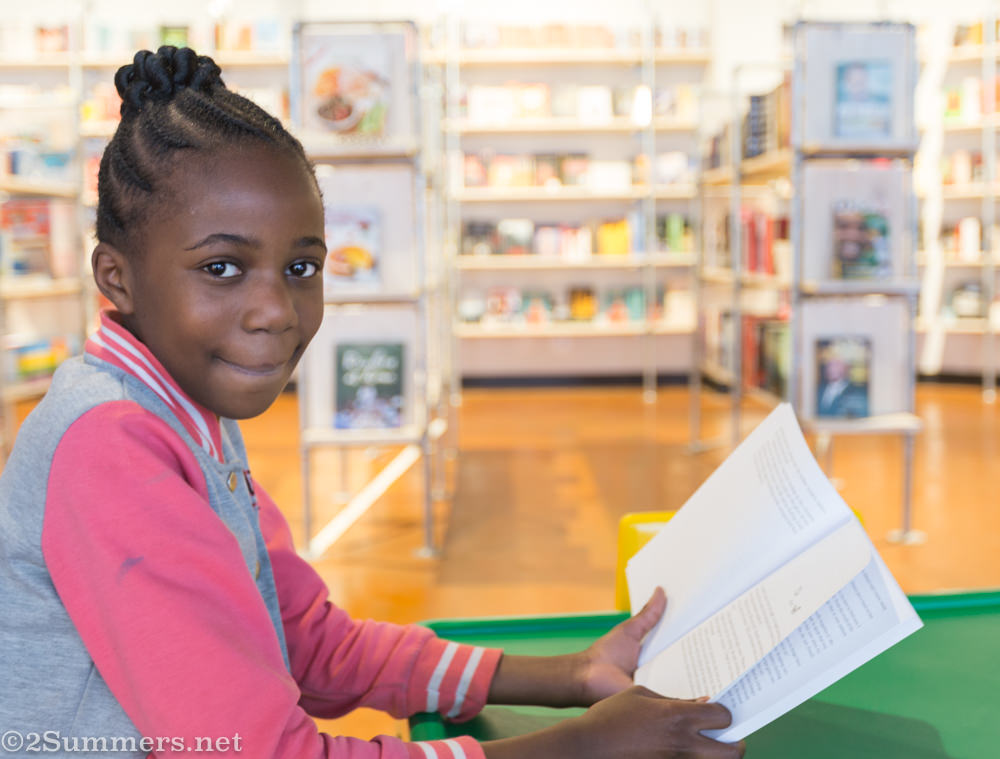 Kid reading at African Flavour Braamfontein