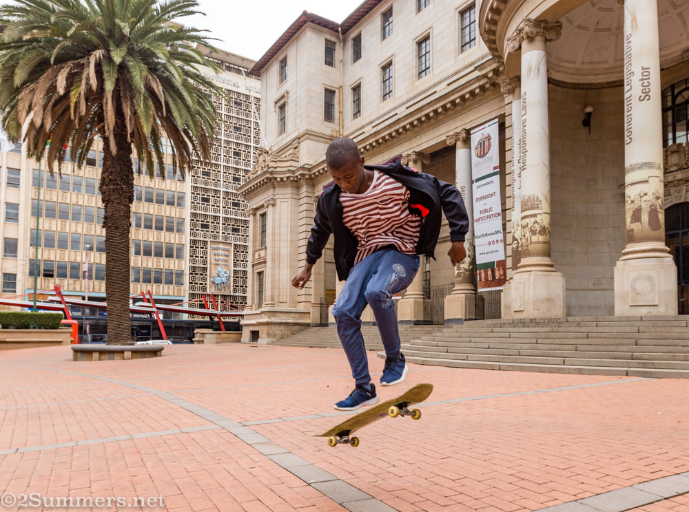 Guy skateboarding in front of legislature