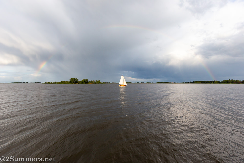 Sailboat and rainbow on a Netherlands canal