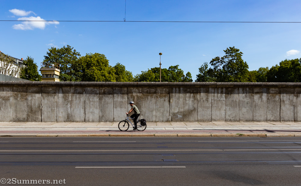 Cyclist passing the Berlin Wall