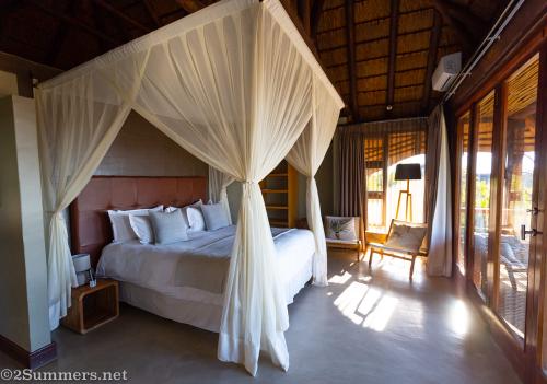 Bedroom in the deluxe suite at Mhondoro Safari Lodge
