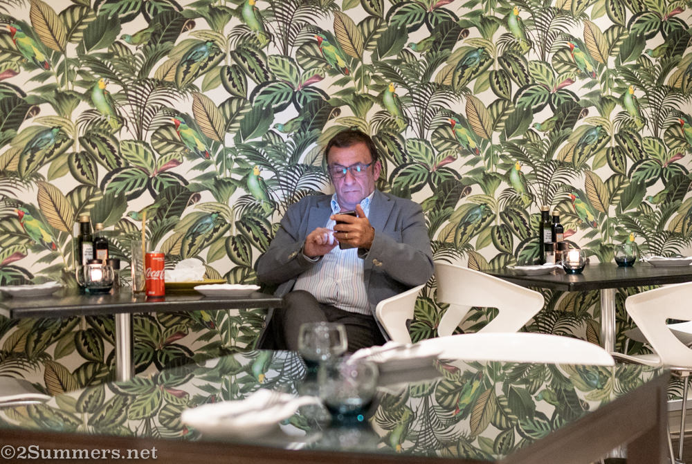 Man on his phone at Bistro Dolce Vita