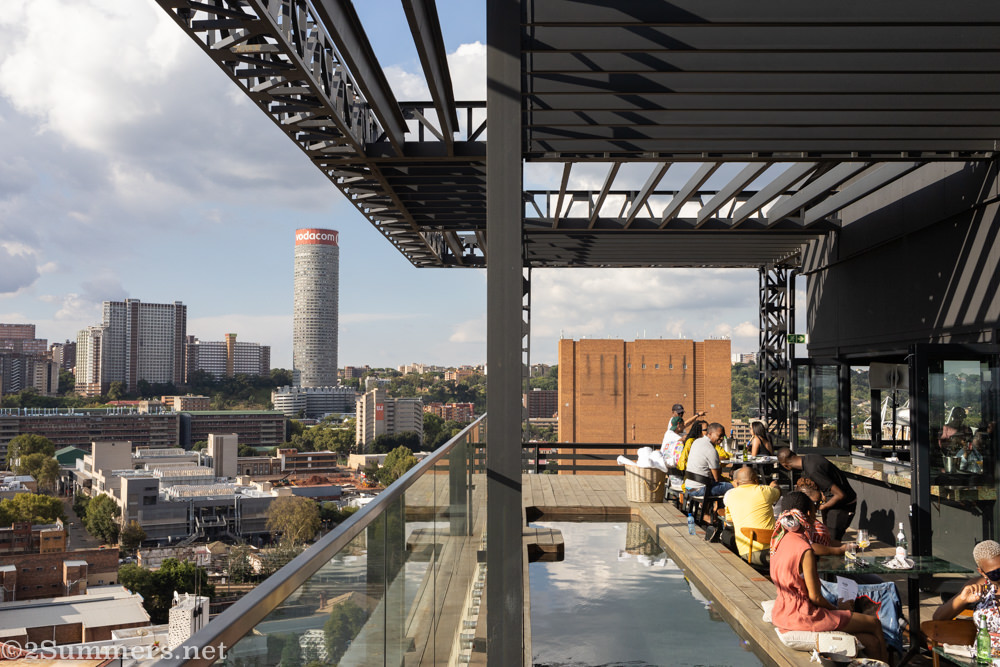 The outdoor bar tables with a view of Hillbrow in the distance. As you can see there is a small swimming pool but no one went in while I was there.