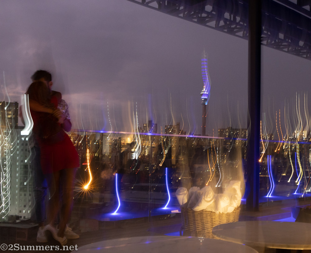Blurry Joburg skyline picture with people kissing