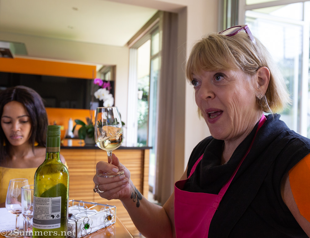 Janice shaking up a glass of wine.