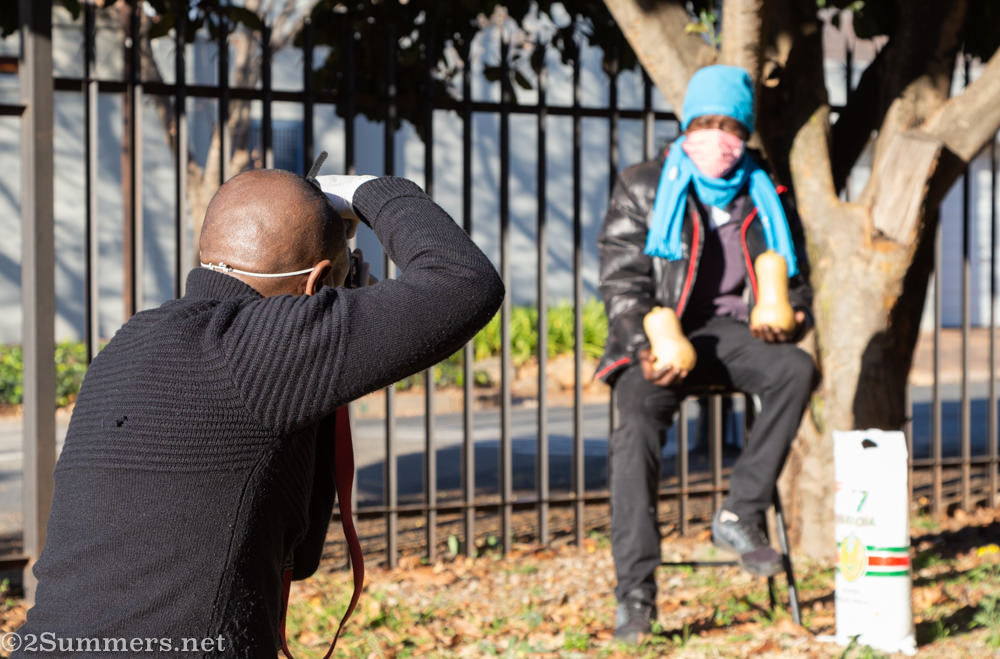 Bonile Bam photographing people at the food program