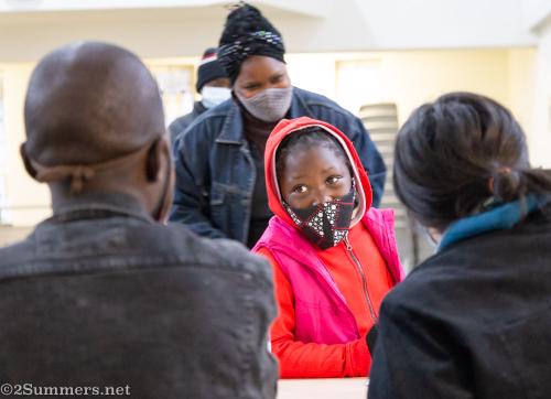 Girl collecting a food parcel in Melville