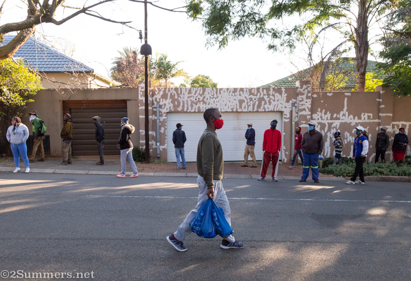 Man carrying food parcel in Melville