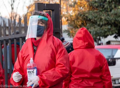 Volunteers in hazmat suits at Melville food parcel distribution