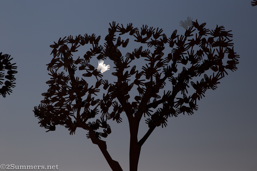 Metal tree sculpture made of hands