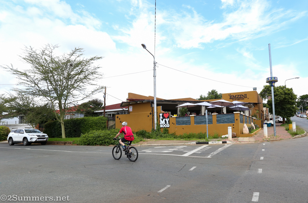Cyclist driving past Emzini Restaurant in Westdene