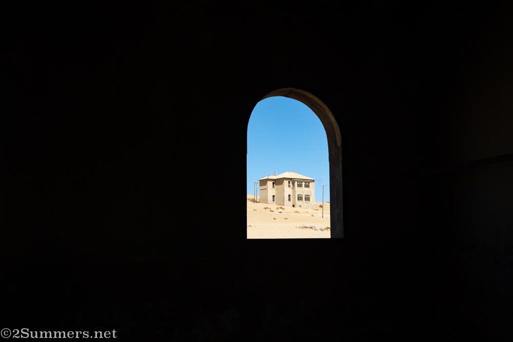 Abandoned building shot through an archway