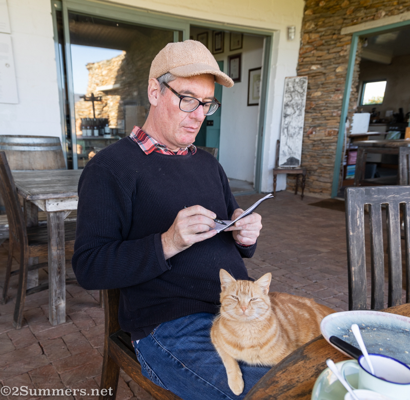 Thorsten sketching with a cat in his lap.