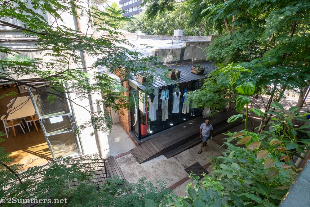 Looking down on a man walking under the trees in 44 Stanley